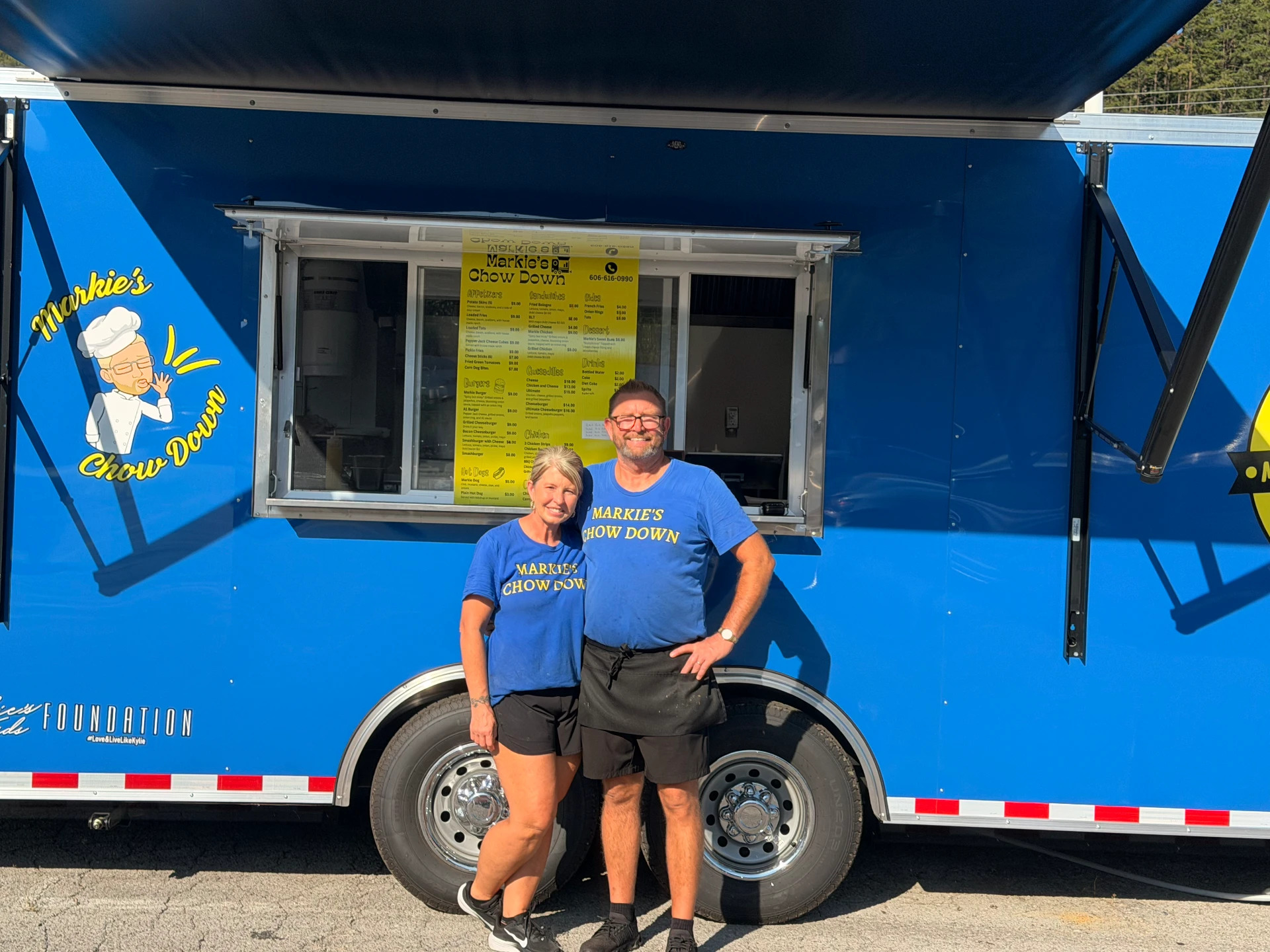 Markie and Tonya standing in front of the Markie's Chow Down food truck